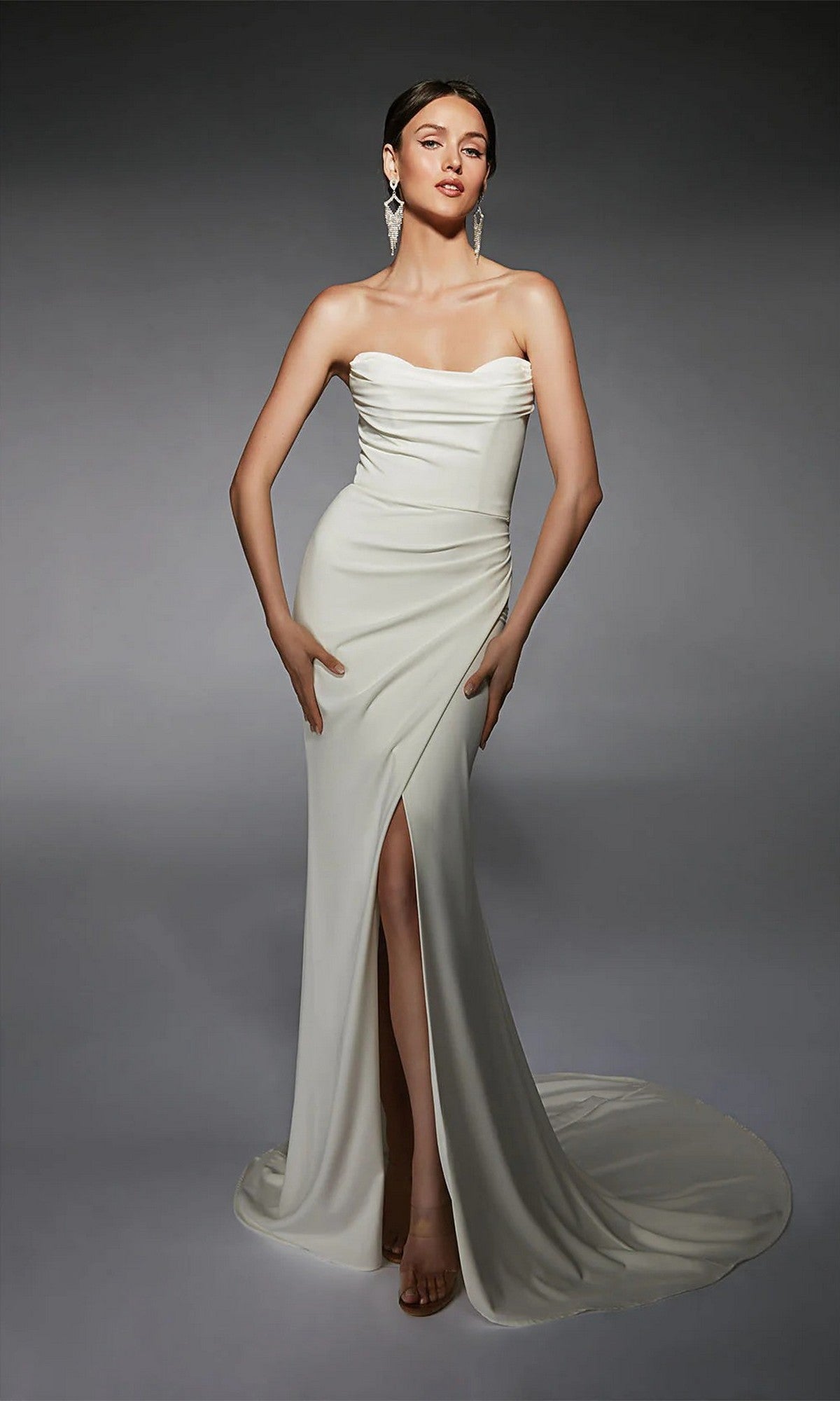 Model wearing the Alyce 7105 long white dress, a strapless formal gown with a thigh-high slit, posed against a plain gray background.